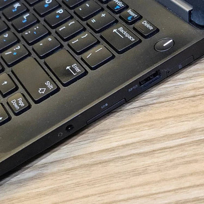 Dell Latitude E7270 business laptop with 8GB RAM and 256GB SSD, shown with external wireless adapter on a workspace.