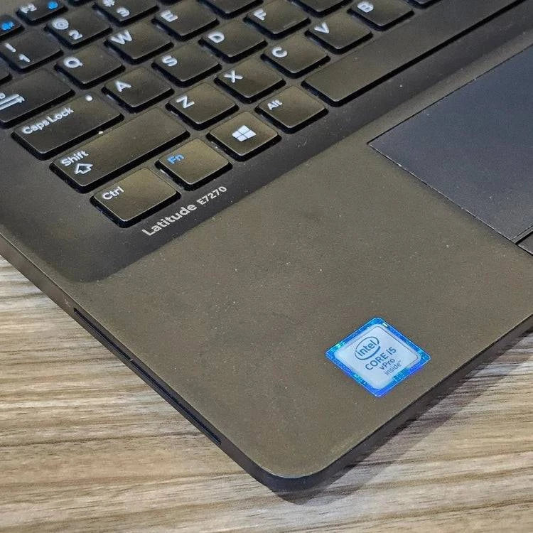 Dell Latitude E7270 business laptop with 8GB RAM, 256GB SSD, and external wireless adapter, shown with sleek silver design.