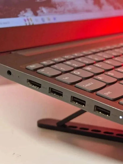 Lenovo Idea V15 laptop with AMD Ryzen 5 processor, 15.6-inch display, silver finish, shown open on a desk.